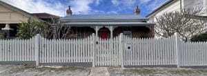 Front picket fence in white built by Gleeson Build
